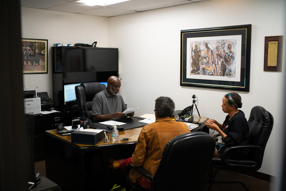 Mark Alston meets with clients at his office on La Tijera Boulevard in Los Angeles. <strong></strong>Unlike most loan officers, Alston works with his clients for months — even years — to disentangle a convoluted loan application process, pay off bills and boost credit scores so they can ultimately qualify for a home loan.