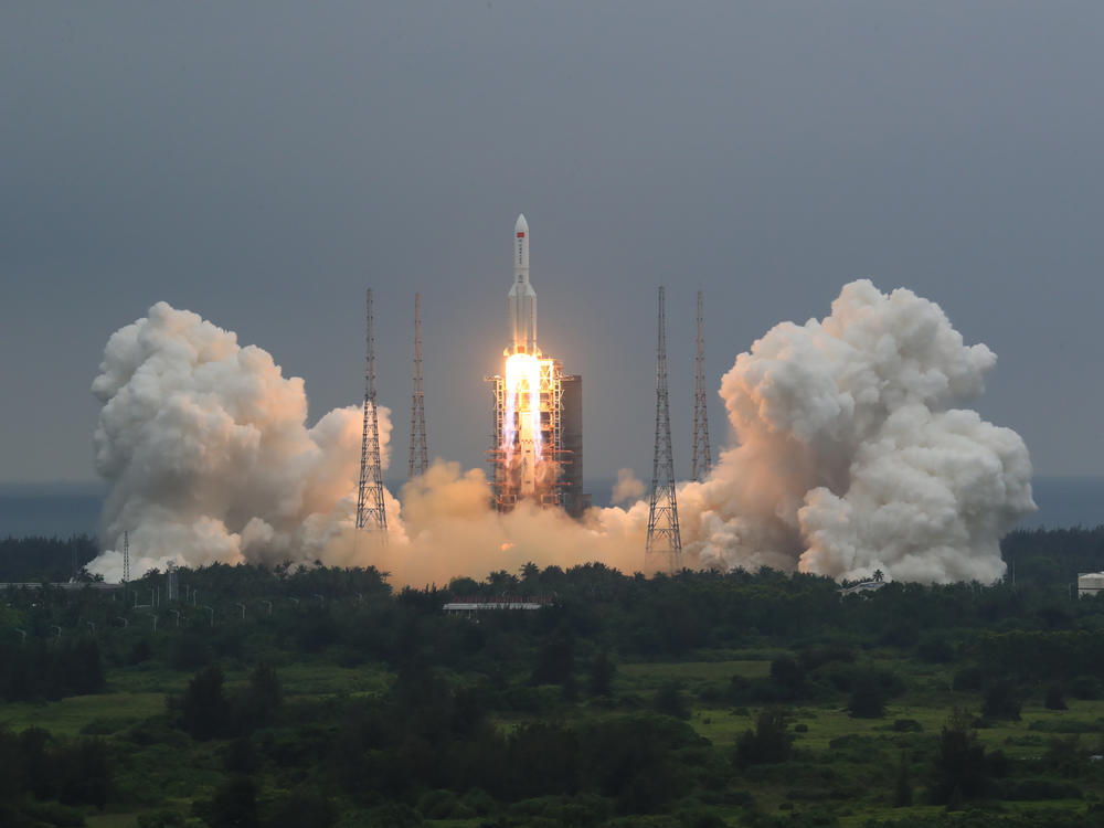 in this April 29, 2021, file photo released by China's Xinhua News Agency, a Long March 5B rocket carrying a module for a Chinese space station lifts off from the Wenchang Spacecraft Launch Site in Wenchang in southern China's Hainan Province.