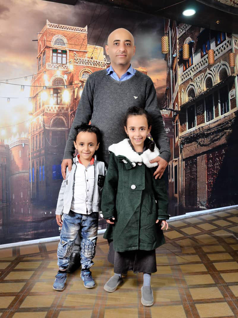 Anwar Alsaeedi stands with his children, Nada, 9, and Mazeen, 6, in Yemen's capital, Sanaa.