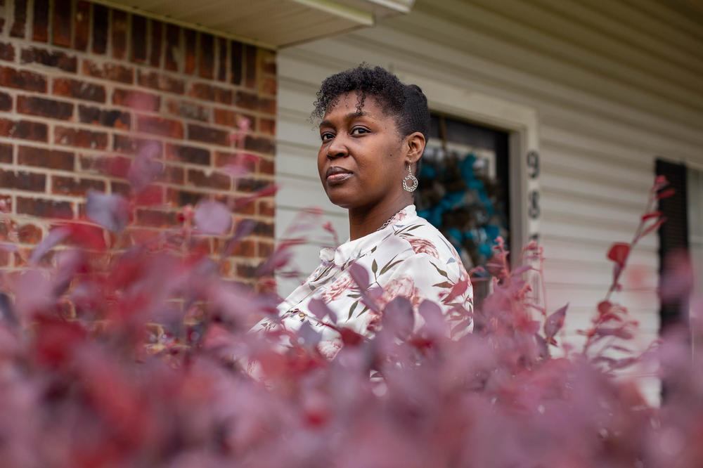 Tia Cunningham stands in front of her home in Byram, Miss., on Wednesday. She's a past recipient of a guaranteed income pilot project in Jackson, and it helped her save up for a down payment.