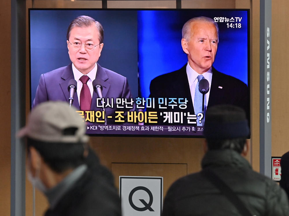 People in Seoul watch a news report in November on the U.S. election, showing images of Joe Biden, newly elected as president, and South Korean President Moon Jae-in.