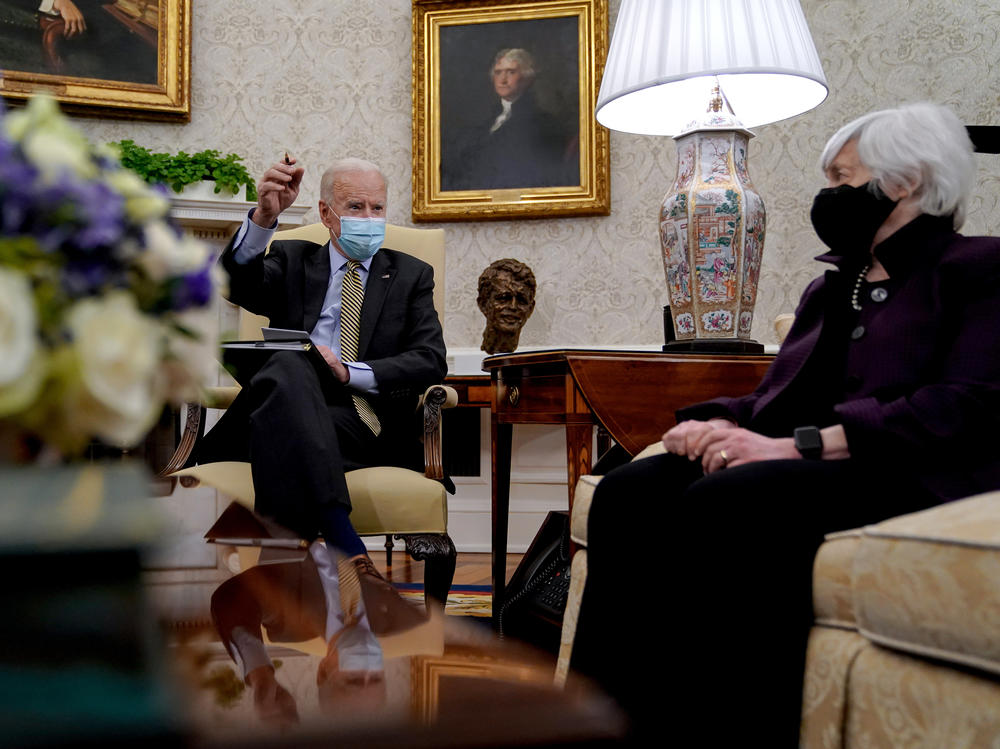 President Biden speaks as Treasury Secretary Janet Yellen listens during the weekly economic briefing in the Oval Office at the White House on April 9. Biden issued an executive order compelling Yellen and other regulators to assess the risk of climate change to America's financial system.