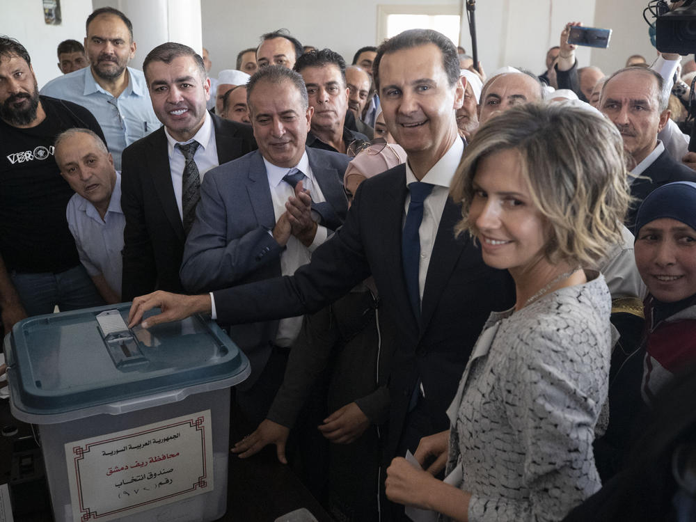 Syrian President Bashar Assad and his wife, Asma, vote at a polling station during the presidential election Wednesday in Douma, near the Syrian capital of Damascus.