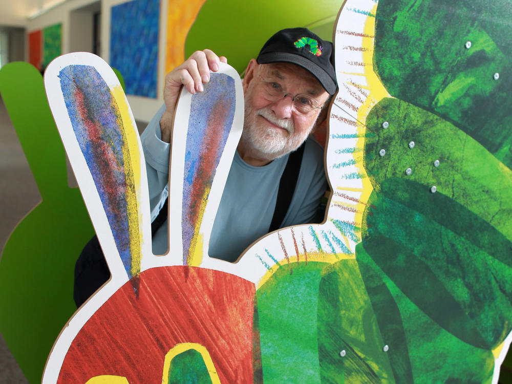 Eric Carle stands with large cutout of the iconic image from his children's book, 