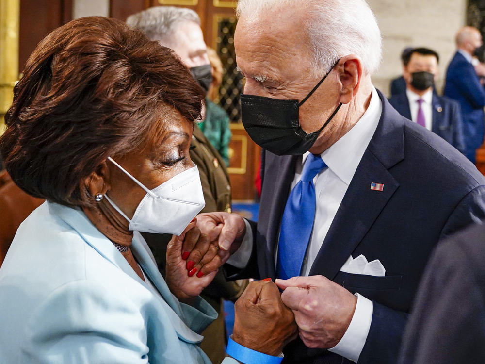 Rep. Maxine Waters fist bumps President Biden at the Capitol on April 28. In an interview with NPR, Waters warns banks she will not be undermined.