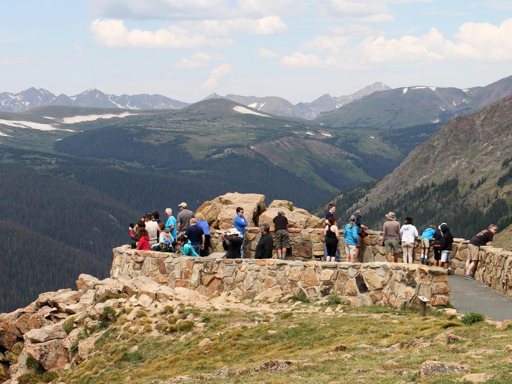 Visitors at a lookout point in Rocky Mountain National Park. Pets are welcome in RMNP, but only in developed campgrounds, roads and picnic areas. They are prohibited on all hiking trails and meadows.