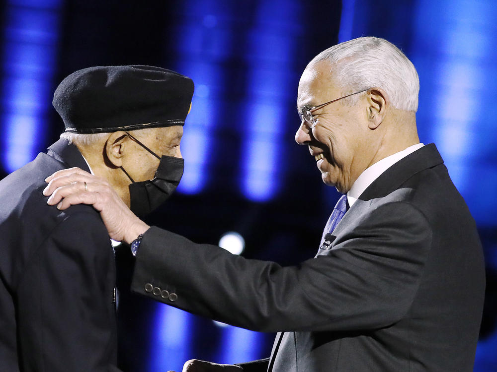 Retired Gen. Colin Powell greets one of the original members of the first all-Black 2nd Army Ranger Infantry Company elite force, at the National Memorial Day Concert broadcast on Sunday.