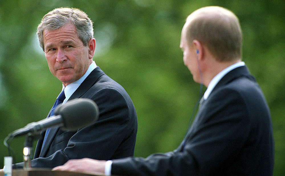 President George W. Bush  glances at Russian President Vladimir Putin during their joint press conference on June 16, 2001, in Slovenia.