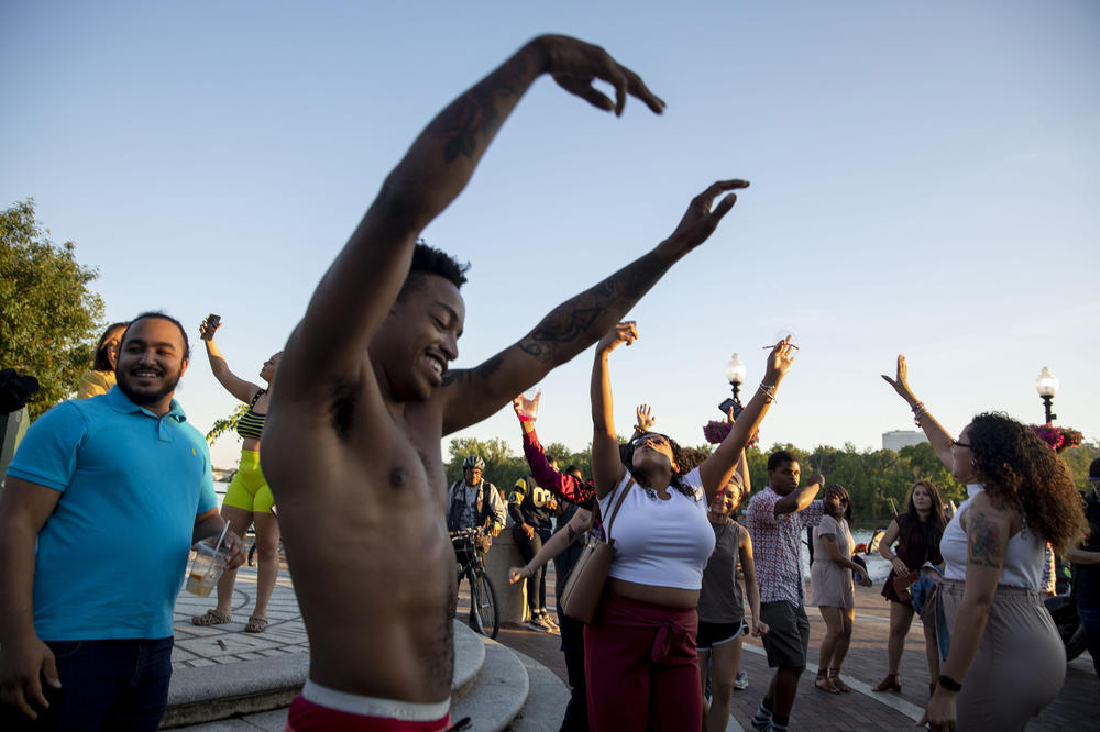 An impromptu dance party gets underway at the Georgetown Waterfront Park in Washington, D.C., as people enjoy beautiful weather and relaxed pandemic restrictions on Memorial Day.