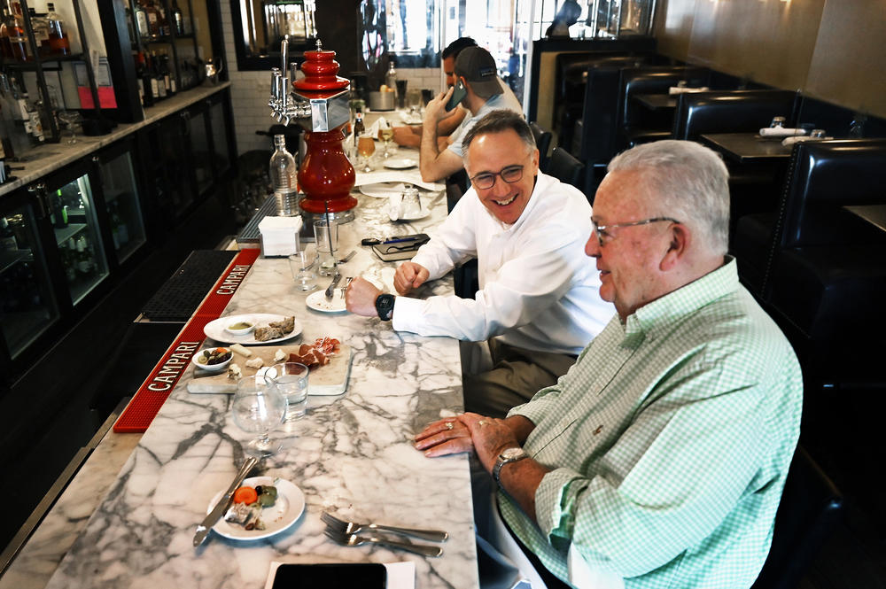 Tom Policelli enjoys lunch with Deacon Dennis Ferguson at Treva restaurant in West Hartford, Conn. 