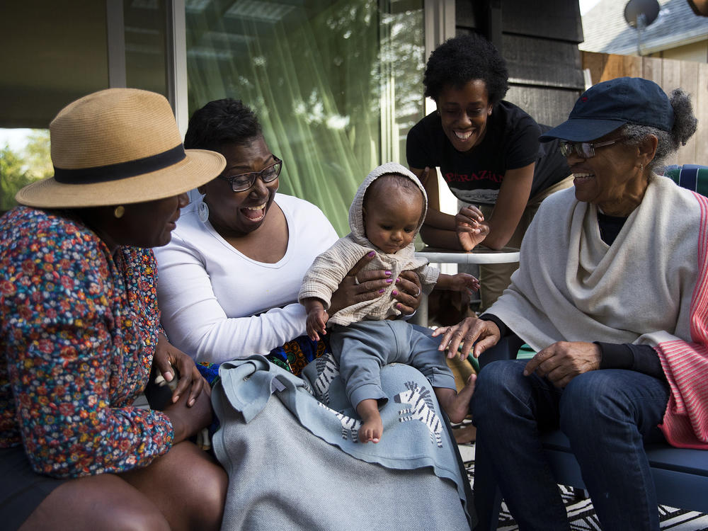 Cassandra Cast (second from  left) and Barbara Arthur (right) traveled to Washington state from Boston and Atlanta, respectively, to meet their grandson for the first time.