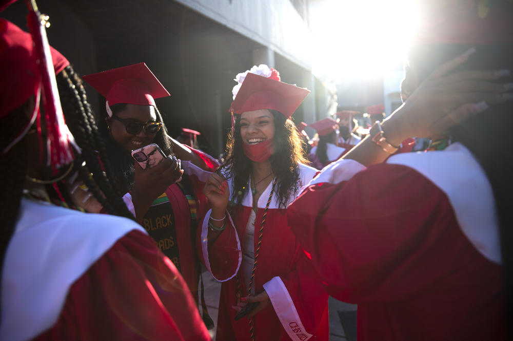 Cleveland STEM High School senior Parris Sanjose laughs with classmates before an in-person commencement ceremony on June 15 at Memorial Stadium in Seattle.