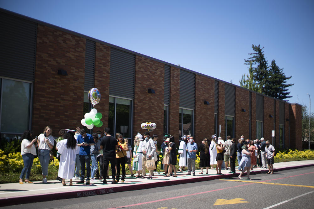Reynolds High School students wait with their families for their turn to graduate. The school hosted about 600 individual ceremonies to allow for social distancing.