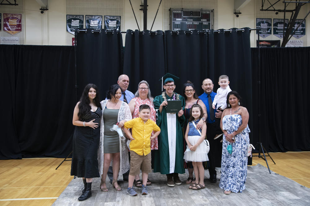Alex Lozowski-Pierce poses with family after his personal graduation ceremony at Reynolds High School in Troutdale, Ore. He called the day a 