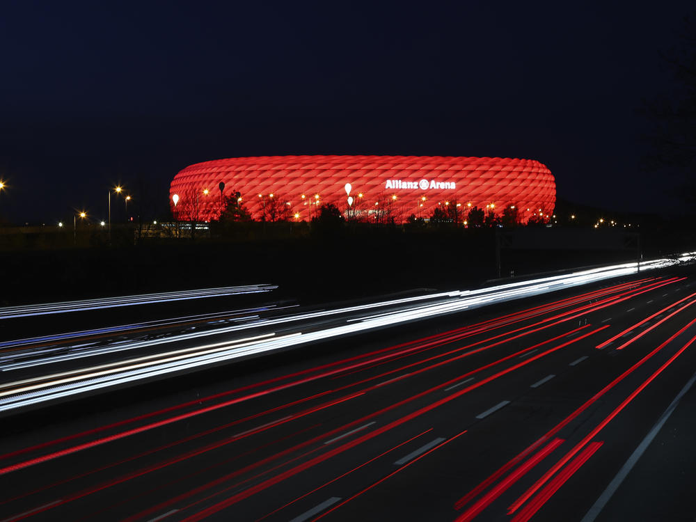 In a photo from March of last year, cars pass the illuminated Allianz Arena soccer stadium in Munich, Germany. UEFA has denied a request by the stadium to light up in rainbow colors Wednesday to protest a new Hungarian law seen as homophobic.