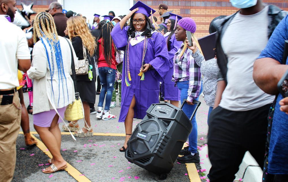 Edna Karr graduate Taylor Morris celebrates outside the Pontchartrain Convention & Civic Center. Morris' aunt, Holly Barnett, brought a rolling boombox that transformed the parking lot into a dance party and second line parade.