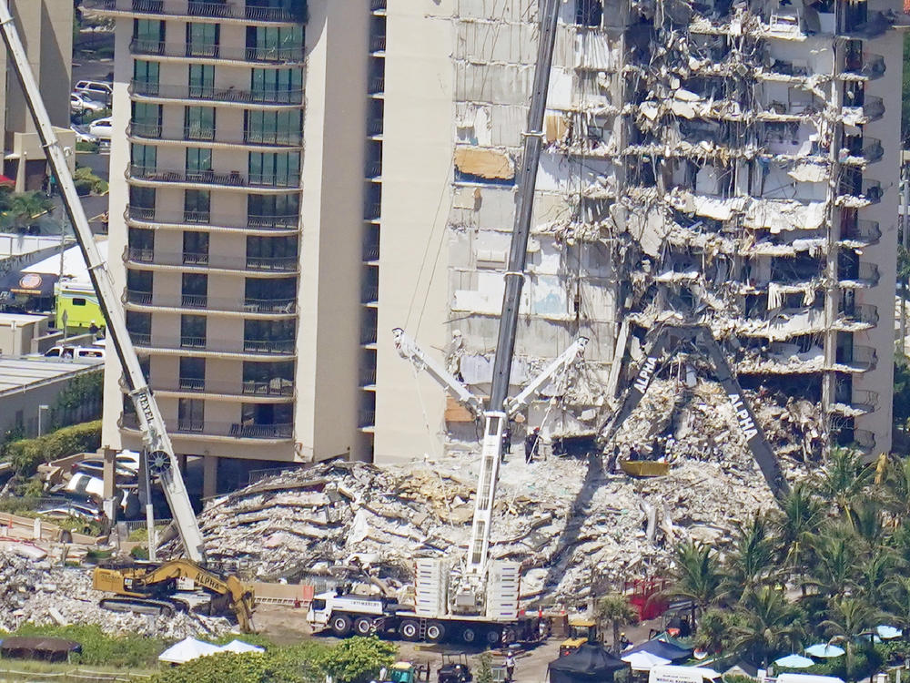 Crews work near a open tunnel, center near the bottom, in the rubble at the Champlain Towers South Condo on Sunday in Surfside, Fla. More than 150 people were still unaccounted for two days after Thursday's collapse.
