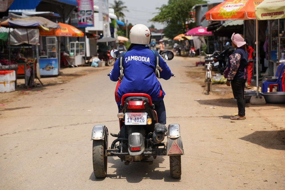 Sinet An gets around on a motorbike adapted for her disability.