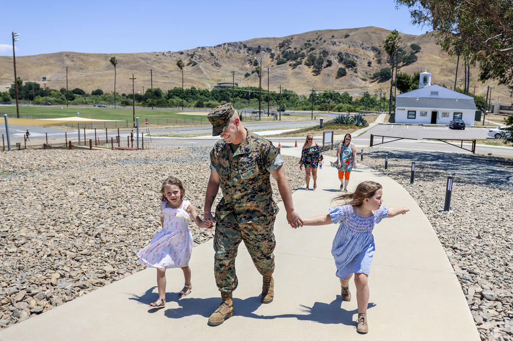 Hardebeck walks to his Purple Heart ceremony with his daughters Adalie and Zoey. He downplayed the incident for which he received the award for several years and only applied for it at the urging of Marines from that deployment.