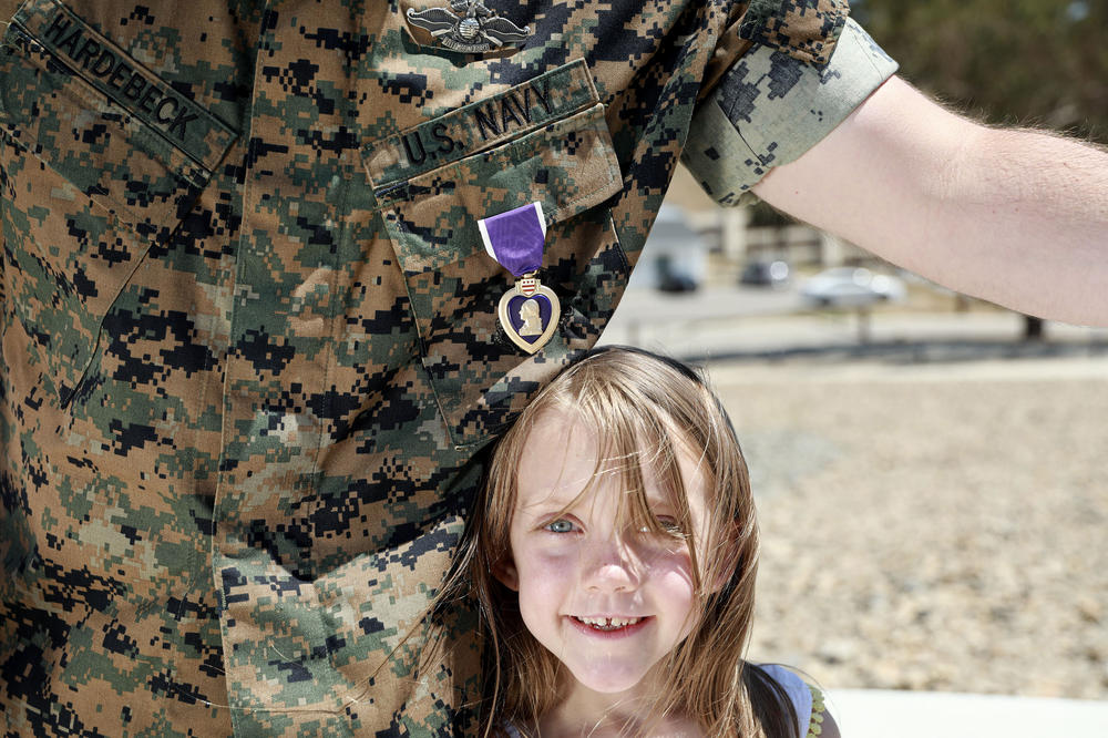 Hardebeck stands with his daughter Adalie and his Purple Heart after the award ceremony. There have been more than 1.8 million Purple Heart recipients since its inception, but Hardebeck believes the number for those who qualify for the award is higher.