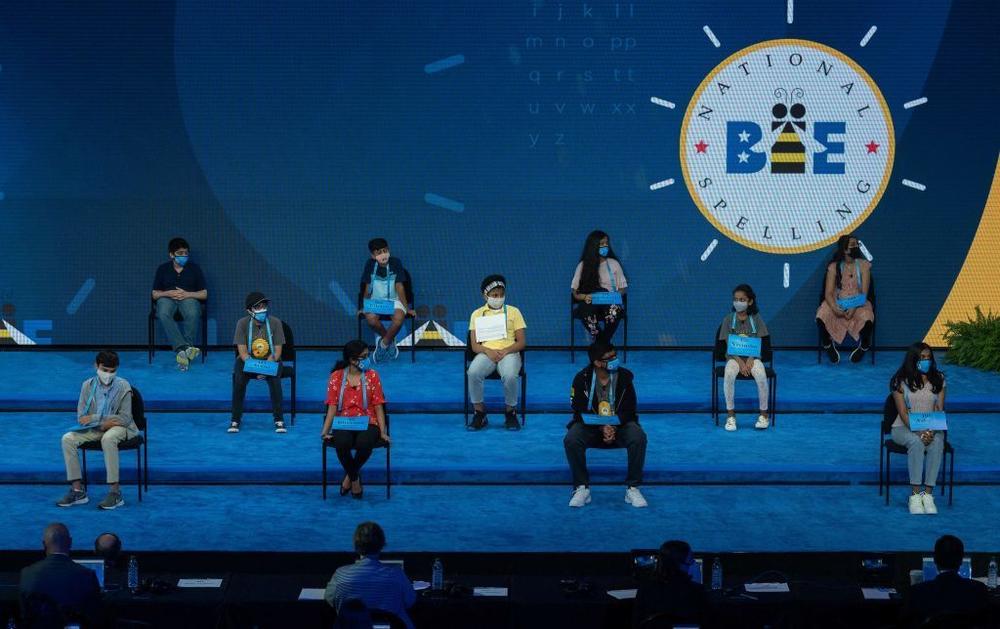 The 11 finalists of the Scripps National Spelling Bee sit onstage as the finals begin Thursday night.
