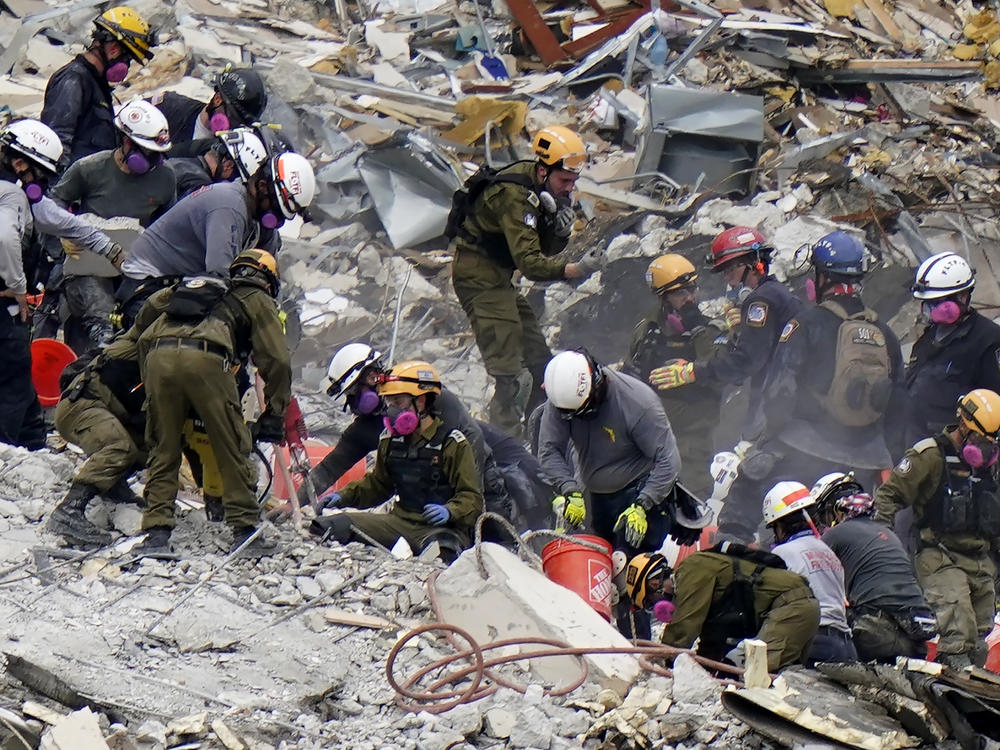 Crews from the United States and Israel work in the rubble of Champlain Towers South condo in Surfside, Fla.