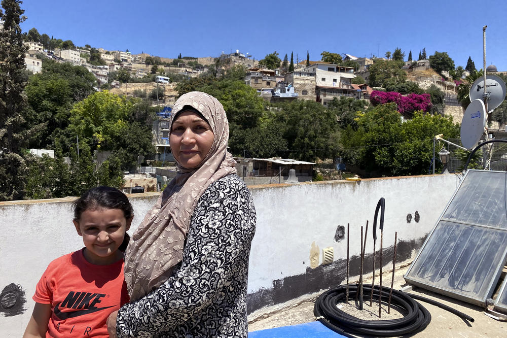 I'tidal Abu Diab with her daughter on the rooftop of their home.