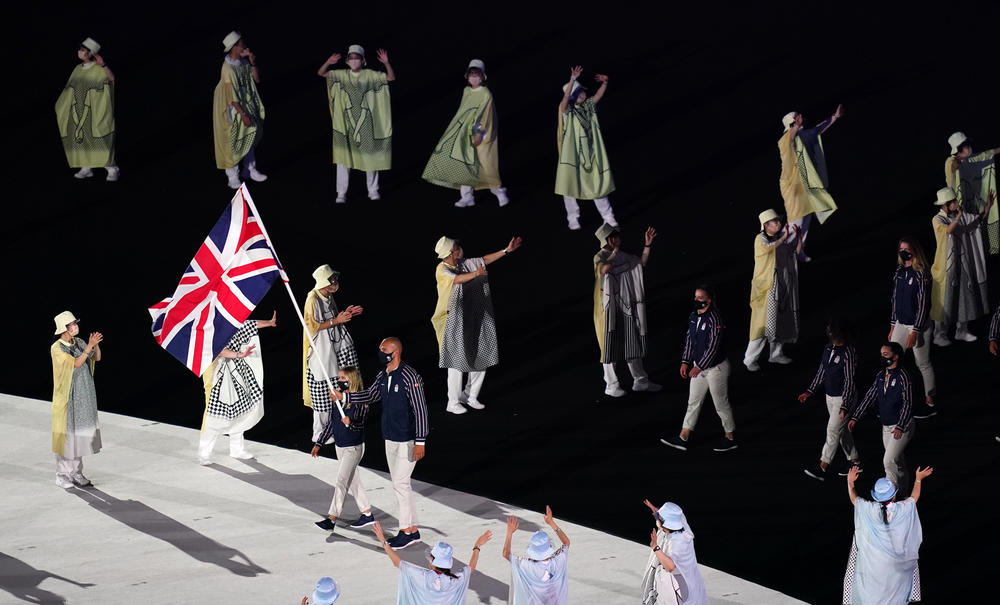 Flag bearers Hannah Mills and Mohamed Sbihi of Great Britain lead out their team during the open ceremony.