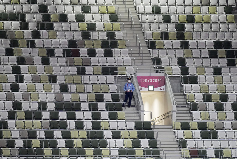 A security officer looks out over an empty stadium before the opening ceremony.