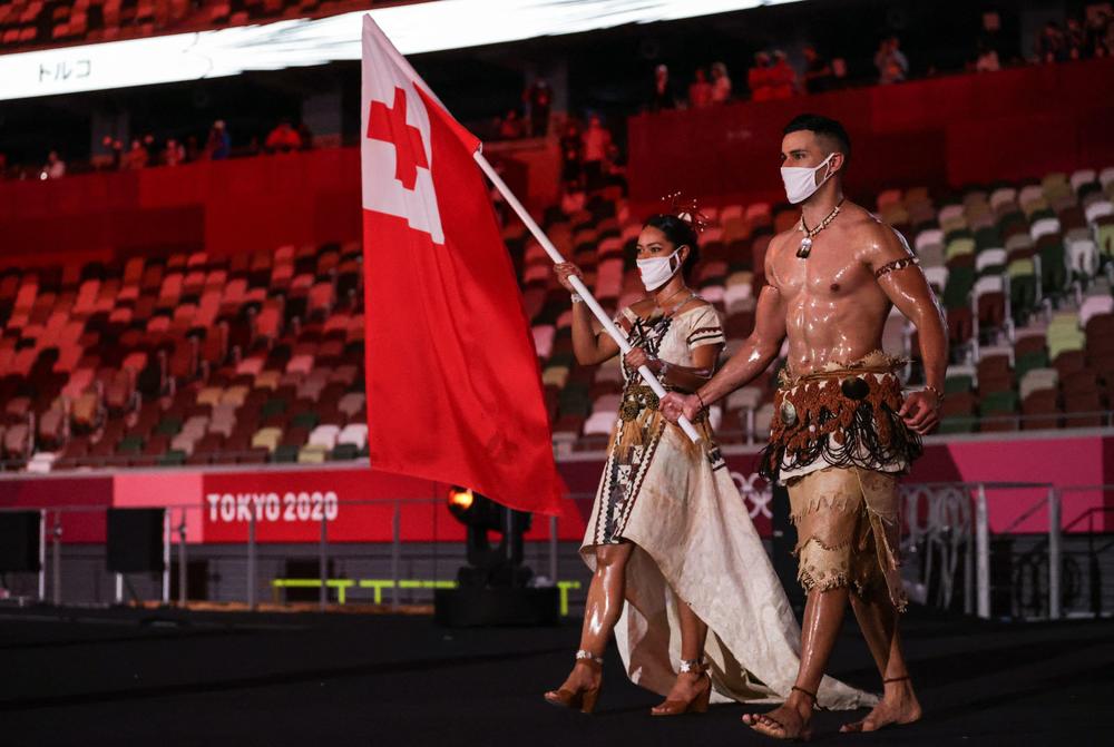 Tonga's flag bearers Malia Paseka (left) and Pita Taufatofua lead their delegation.