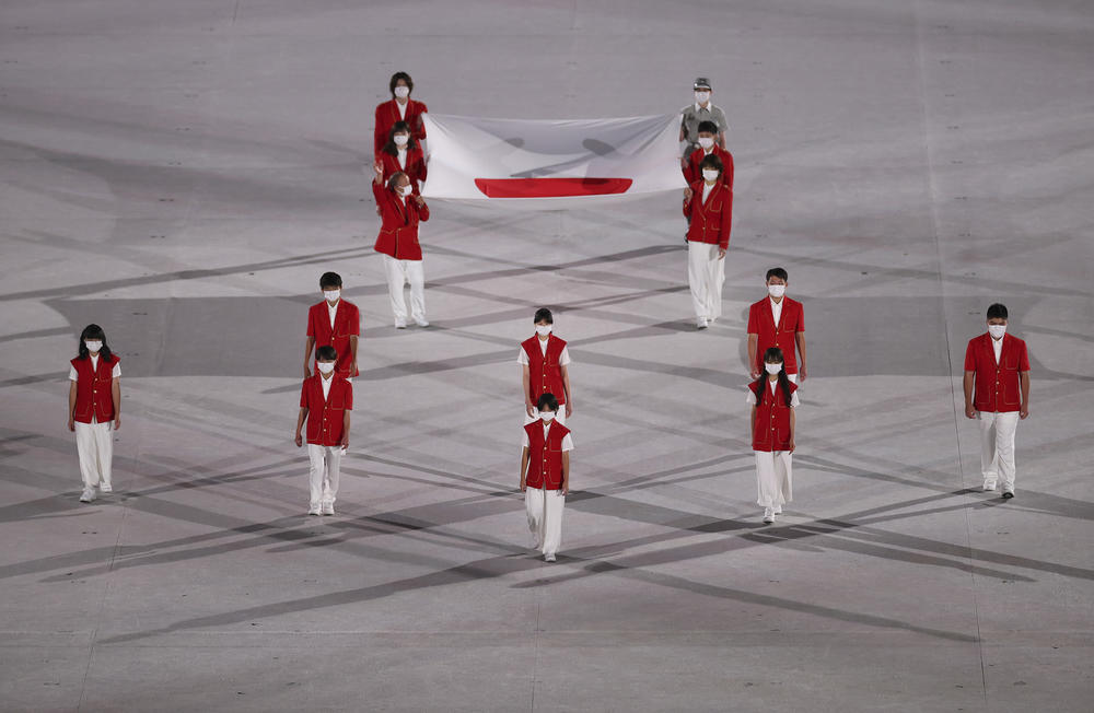 The Japanese national flag comes onto the stage during the opening ceremony.