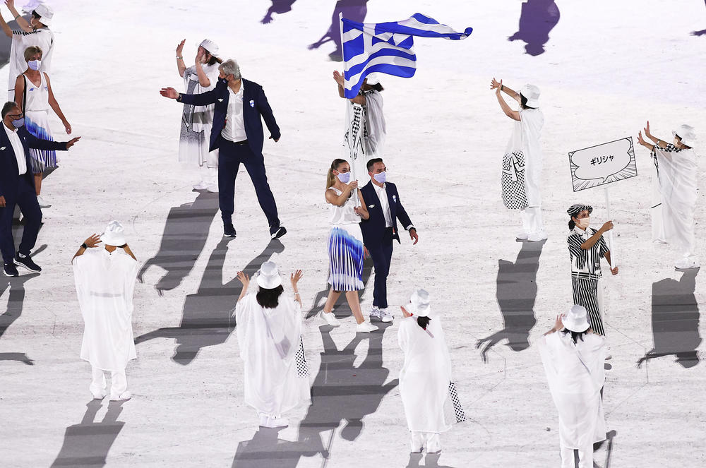 Flag bearers Anna Korakaki and Eleftherios Petrounias of Greece lead their teammates out during the opening ceremony.