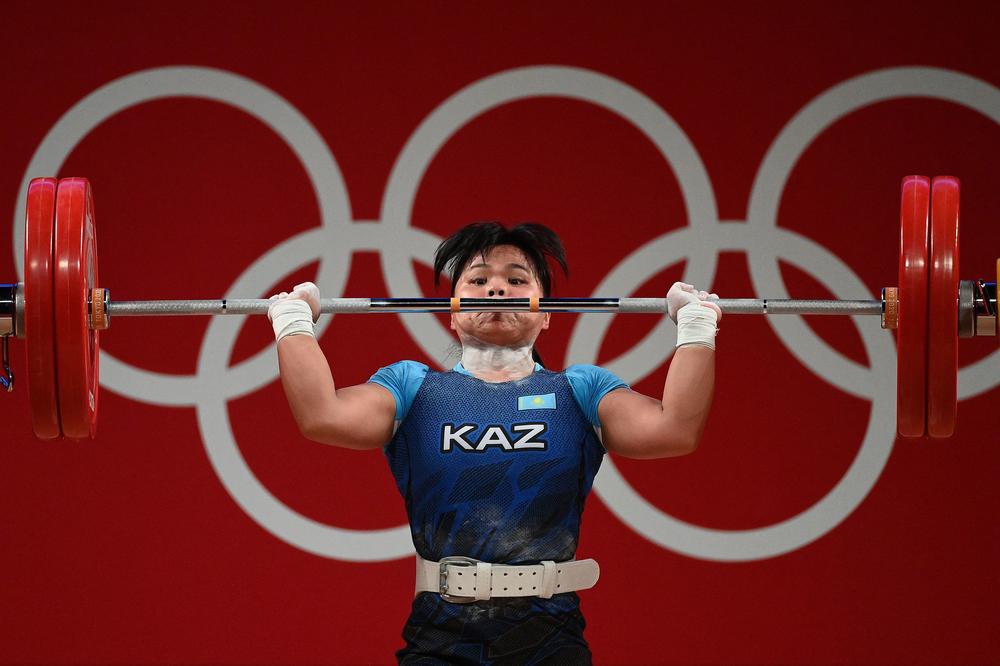 Kazakhstan's Zulfiya Chinshanlo competes in the women's 55kg weightlifting competition on July 26, 2021. Chinshanlo ended in third place, receiving the bronze medal.