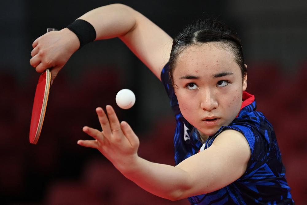 Japan's Mima Ito serves to Portugal's Fu Yu during her women's singles round 3 table tennis match on July 27, 2021.