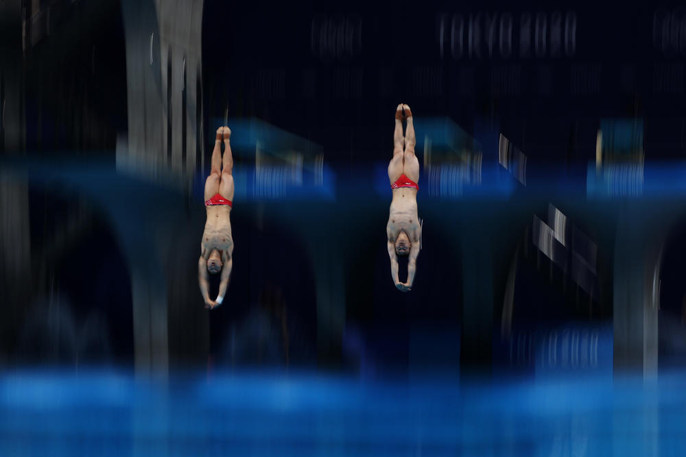 Zongyuan Wang and Siyi Xie of Team China compete during the Men's Synchronised 3m Springboard final to win the gold medal on July 28, 2021.