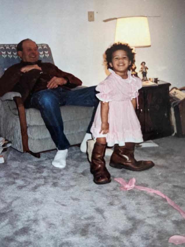Toddler Libby Stroik stomps around in her grandfather's boots in 1993.