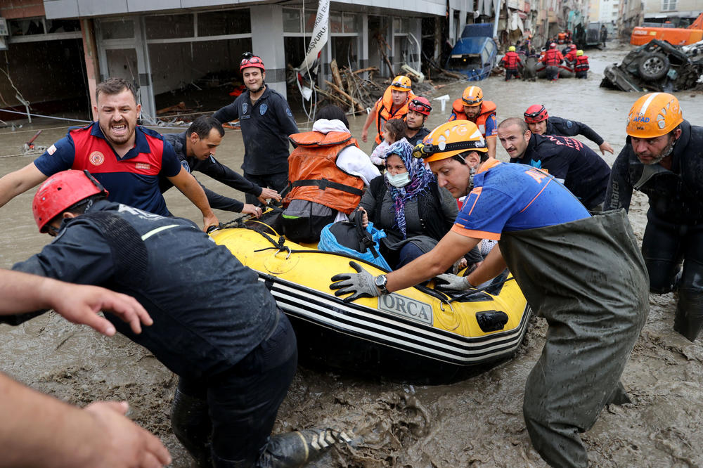 Rescue team evacuates residents in a boat in a residential area affected by floods after heavy rains in Bozkurt district of Kastamonu, Turkey on August 12, 2021. Aerial and ground rescue operations continue in the flood devastated areas in the city.