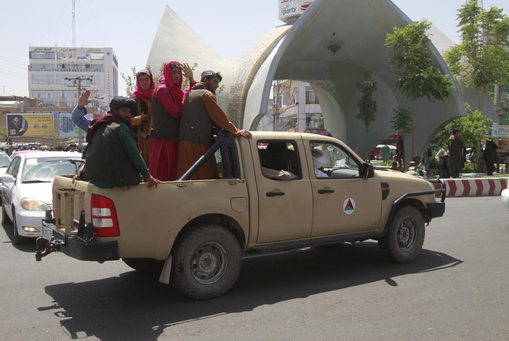 <strong>Sat., Aug. 14:</strong> Taliban fighters pose on the back of a vehicle in the city of Herat, west of Kabul.