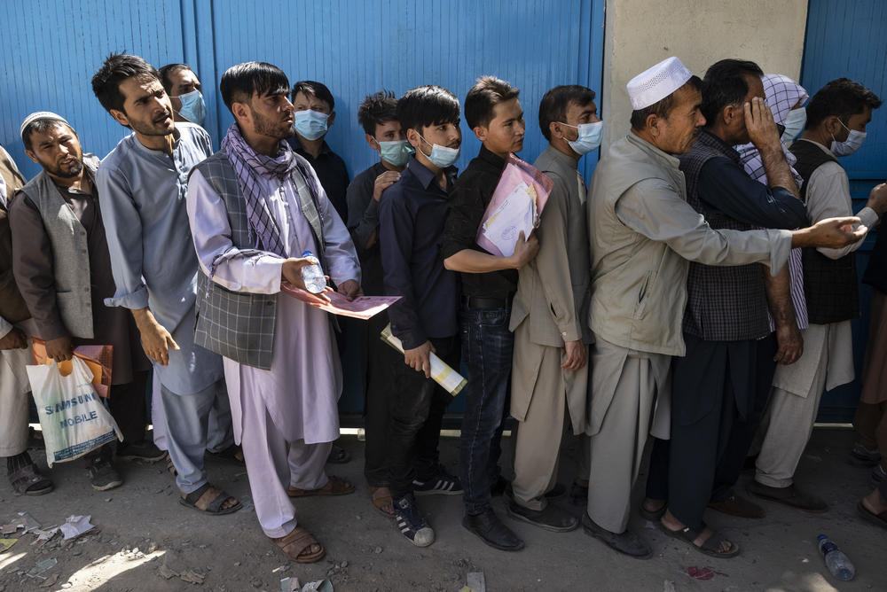 <strong>Sat., Aug. 14:</strong> Afghans wait in long lines for hours at the passport office as many are desperate to have their travel documents ready to go on in Kabul.