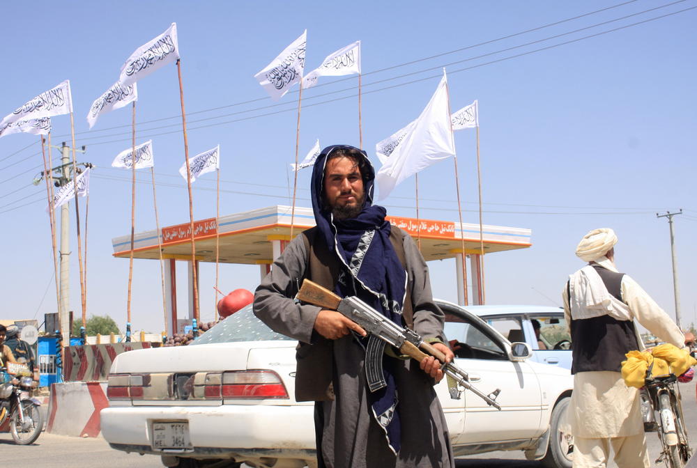 <strong>Sat., Aug. 14:</strong> A Taliban fighter looks on as he stands at the city of Ghazni.
