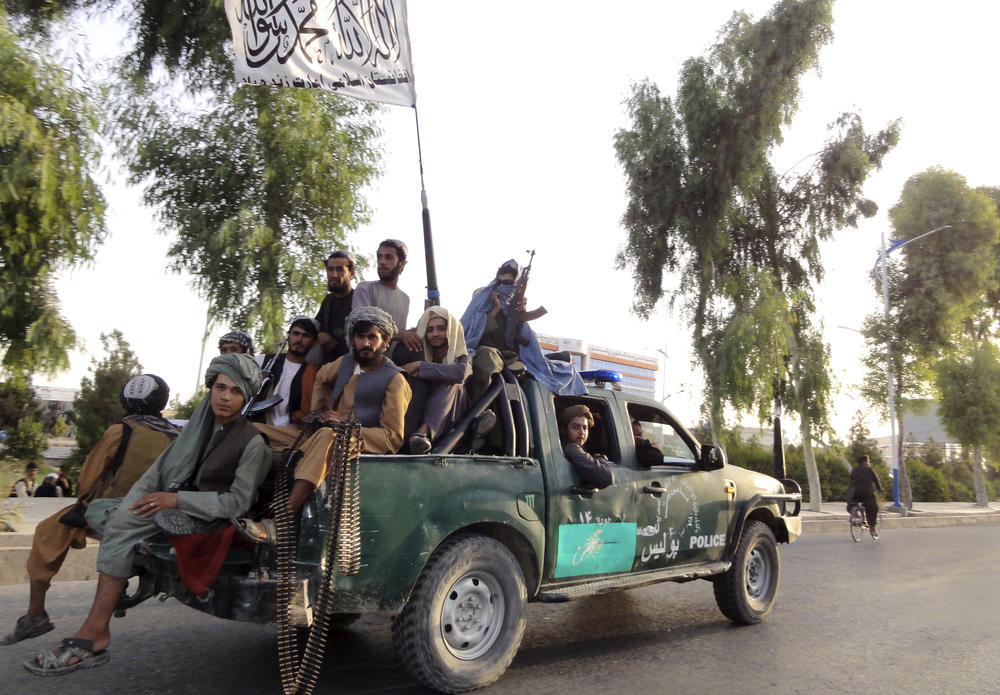 <strong>Sun., Aug. 15:</strong> Taliban fighters patrol inside the city of Kandahar, southwest Afghanistan.