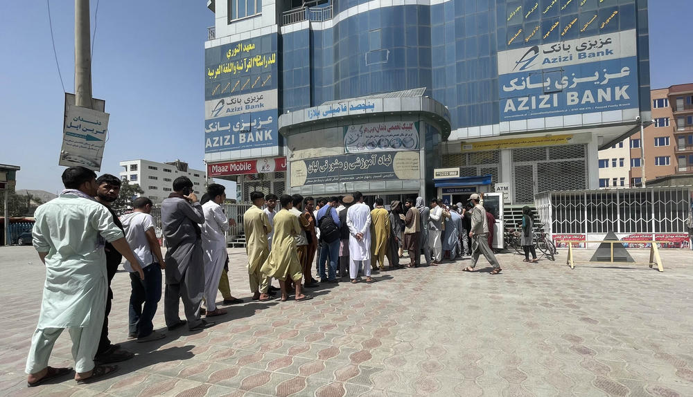 <strong>Sun., Aug. 15:</strong> Afghan people line up outside AZIZI Bank to take out cash as the Bank suffers amid money crises in Kabul, Afghanistan, on August 15, 2021.