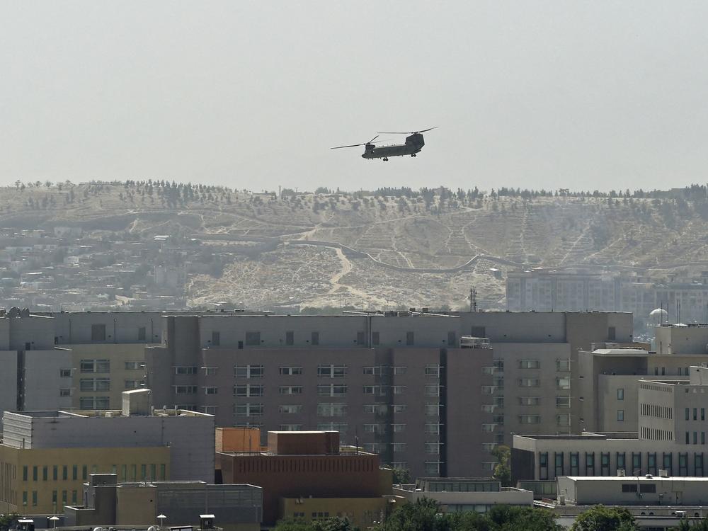 A U.S. military helicopter is pictured flying above the U.S. Embassy in Kabul on Sunday. The Taliban swept into Kabul, facing little resistance.