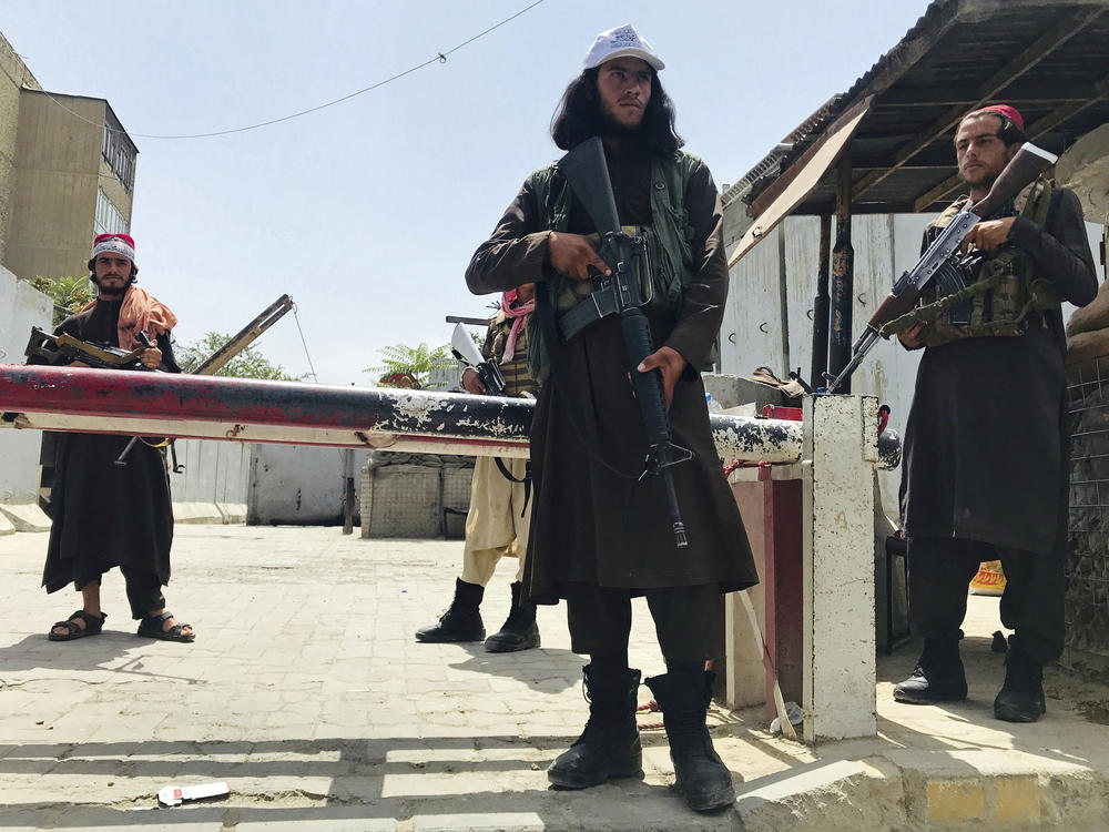 Taliban fighters stand guard at a checkpoint near the U.S. embassy that was previously manned by American troops, in Kabul, Afghanistan, Tuesday.