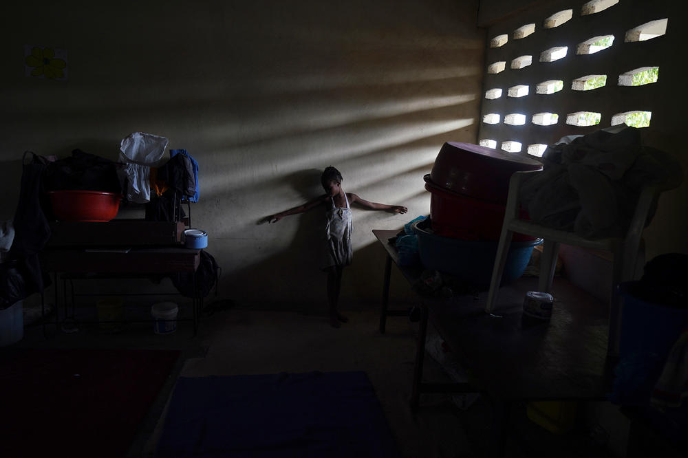 A girl plays inside a classroom on Wednesday where her family is staying at a school turned into a shelter for those displaced by the 7.2 magnitude earthquake in Les Cayes, Haiti.
