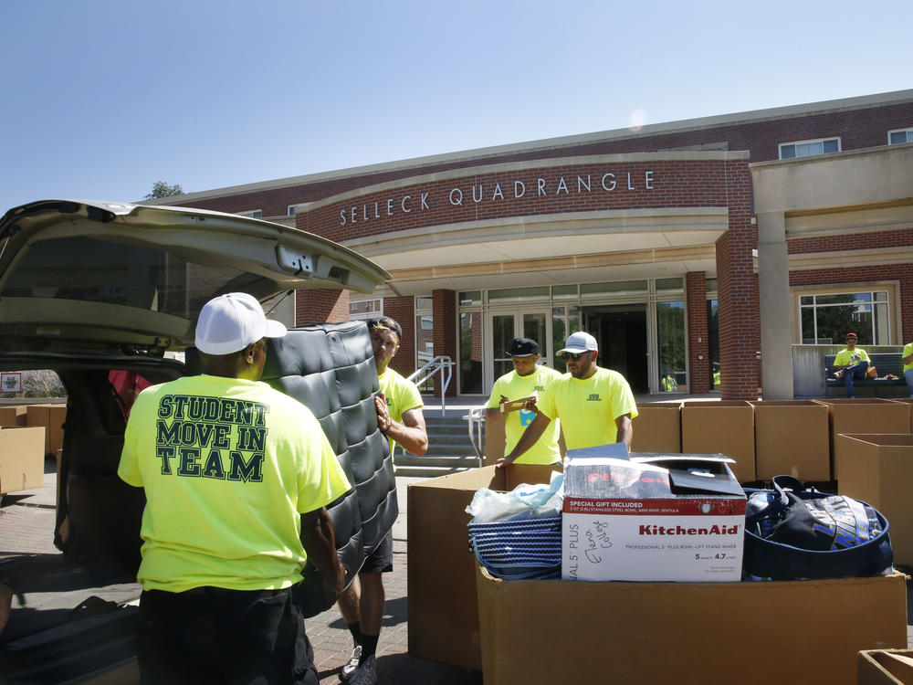 Workers help students move in to Selleck Hall, at the University of Nebraska–Lincoln.