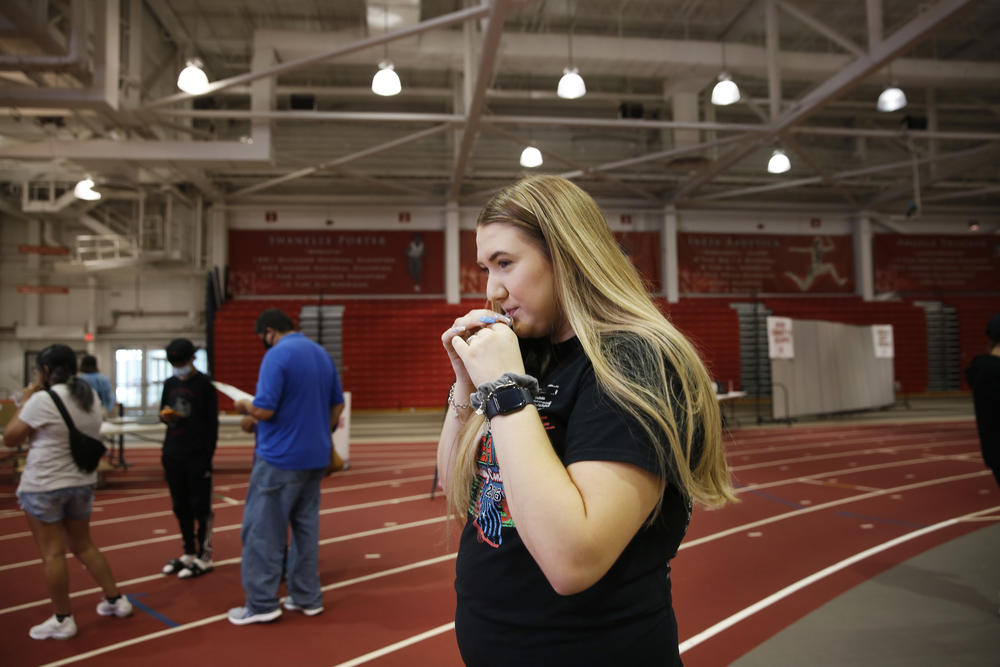 Ariana Huey, a sophomore at the University of Nebraska-Lincoln, takes a saliva-based COVID-19 test upon arrival on campus.