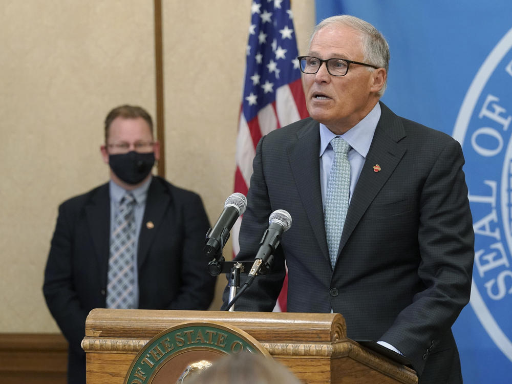 Washington Gov. Jay Inslee speaks at a news conference Wednesday at the state Capitol in Olympia. Inslee announced that Washington state is expanding its vaccine mandate to include all public, charter and private school teachers and staff as well as those working at the state's colleges and universities.