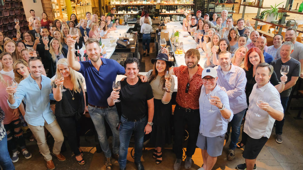 Record executives, musicians and more at Barcelona Wine Bar in the Edgeville neighborhood of Nashville. Center, Scott Borchetta, founder of Big Machine Records, with the members of <a href=