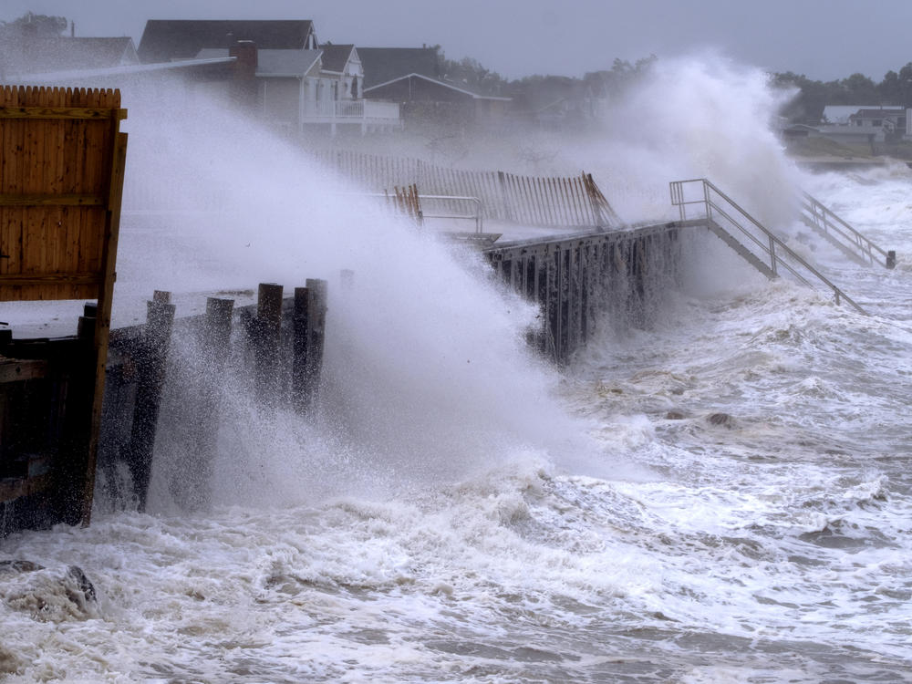 Waves pound a seawall in Montauk, N.Y., on Sunday, as Tropical Storm Henri affects the Atlantic Coast.